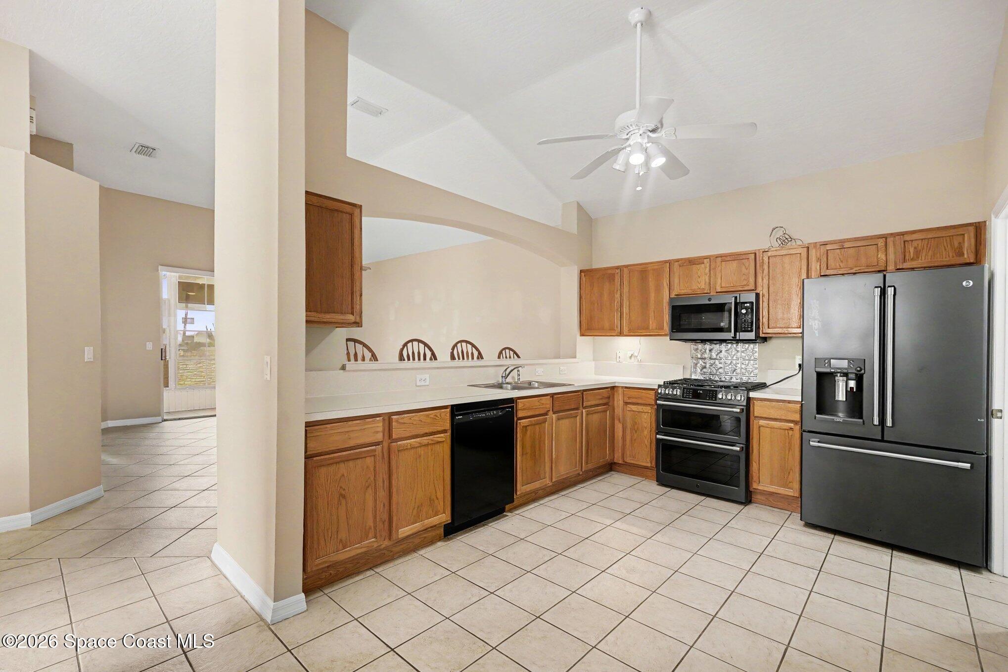 284 Intrepid Way Indialantic, FL 32903 - Photo 15 of 36 a large kitchen with cabinets and stainless steel appliances