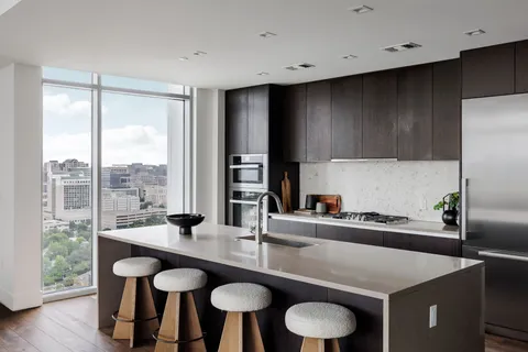 a kitchen with granite countertop a table chairs stove and granite counter tops