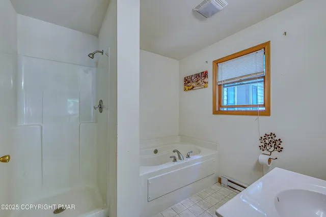 a bathroom with a bathtub and shower