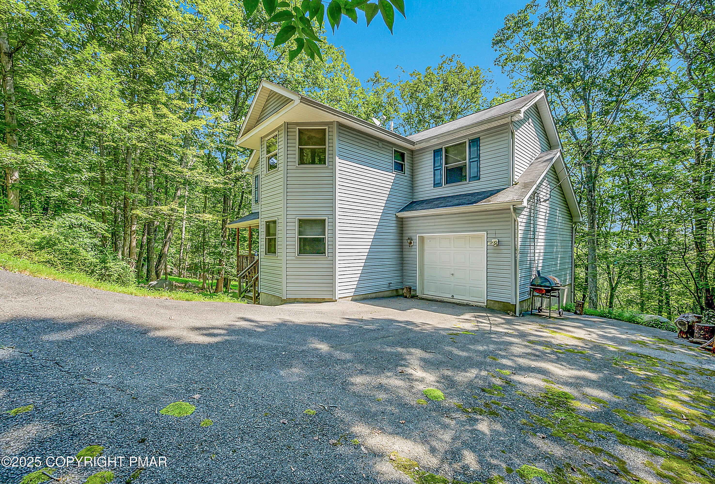 164 Bellingham Drive Bushkill, PA 18324 - Photo 2 of 46 a front view of a house with a yard and garage