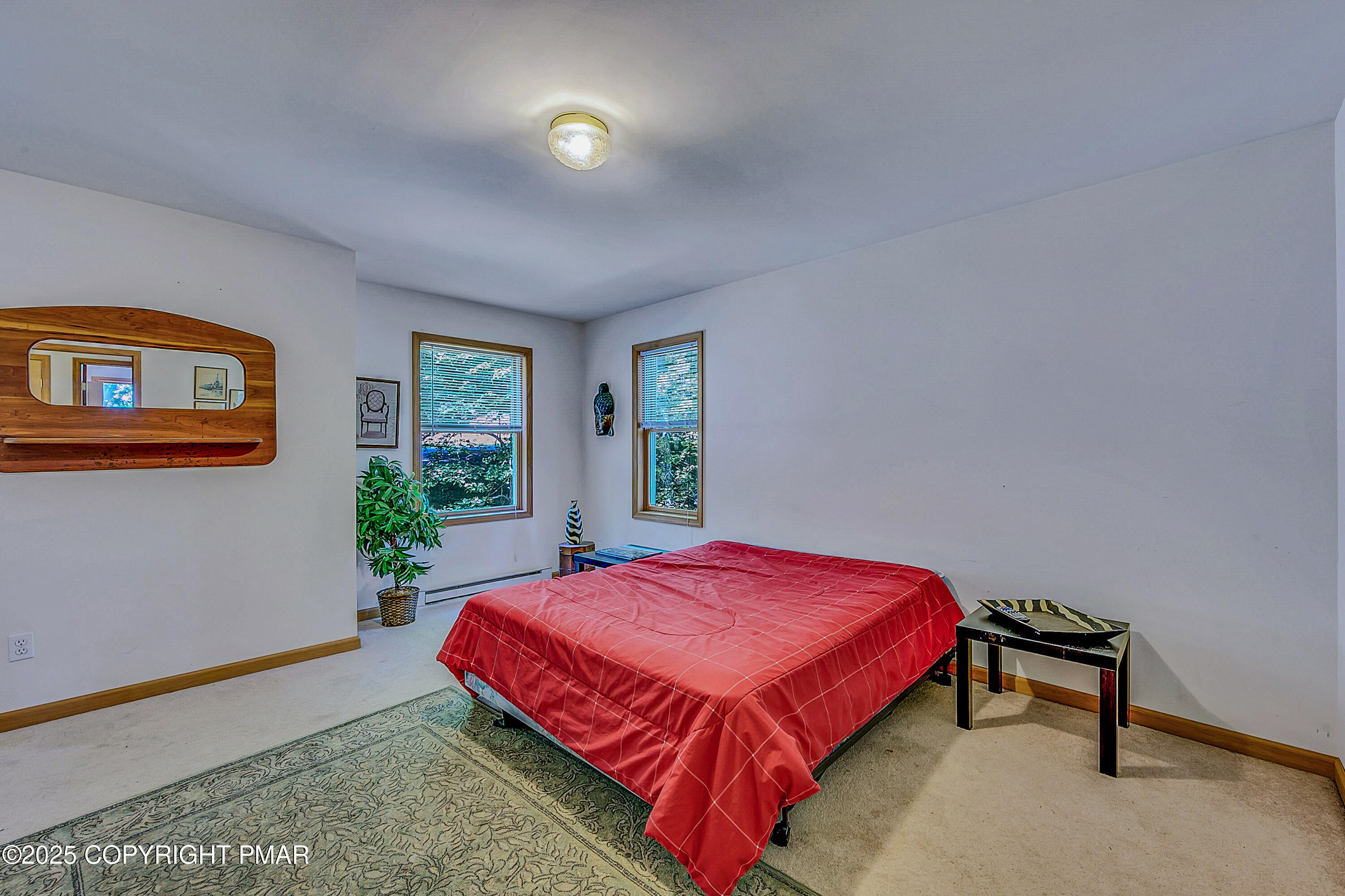 164 Bellingham Drive Bushkill, PA 18324 - Photo 24 of 46 a bedroom with a bed and a potted plant