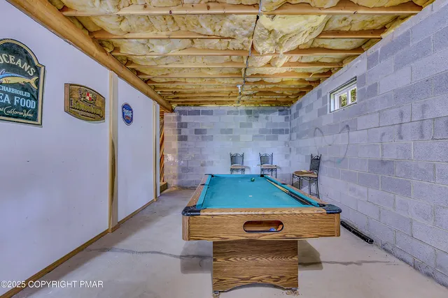 a backyard of a house with chairs and a table