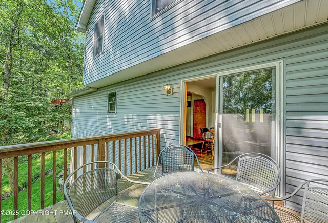 a backyard of a house with table and chairs