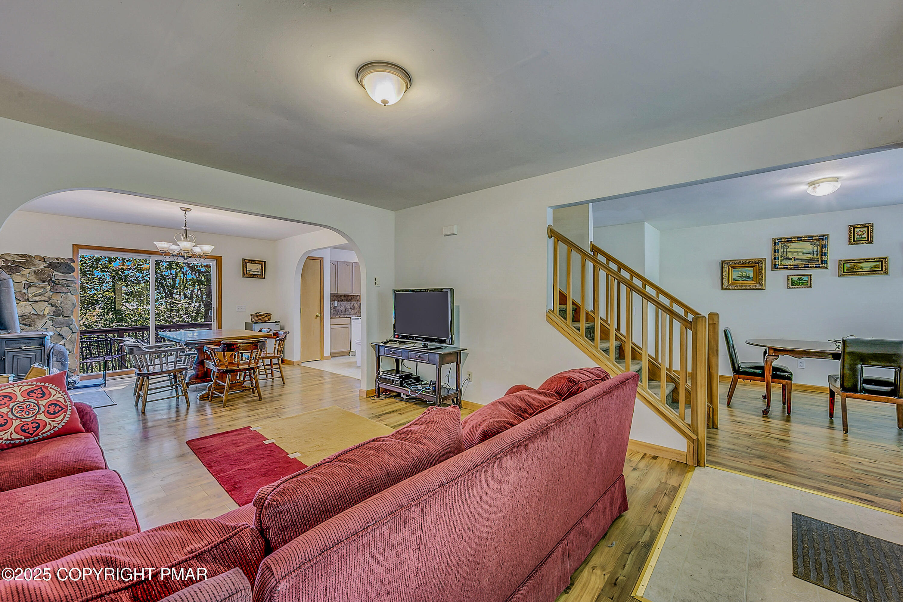 164 Bellingham Drive Bushkill, PA 18324 - Photo 5 of 46 a living room with furniture and a dining table with wooden floor