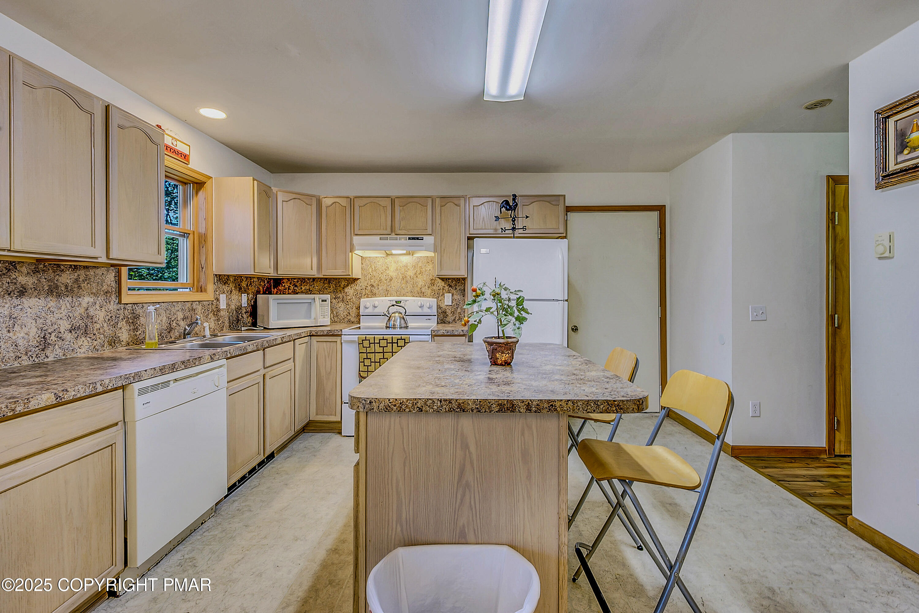 164 Bellingham Drive Bushkill, PA 18324 - Photo 10 of 46 a kitchen with kitchen island granite countertop counter top space cabinets and stainless steel appliances