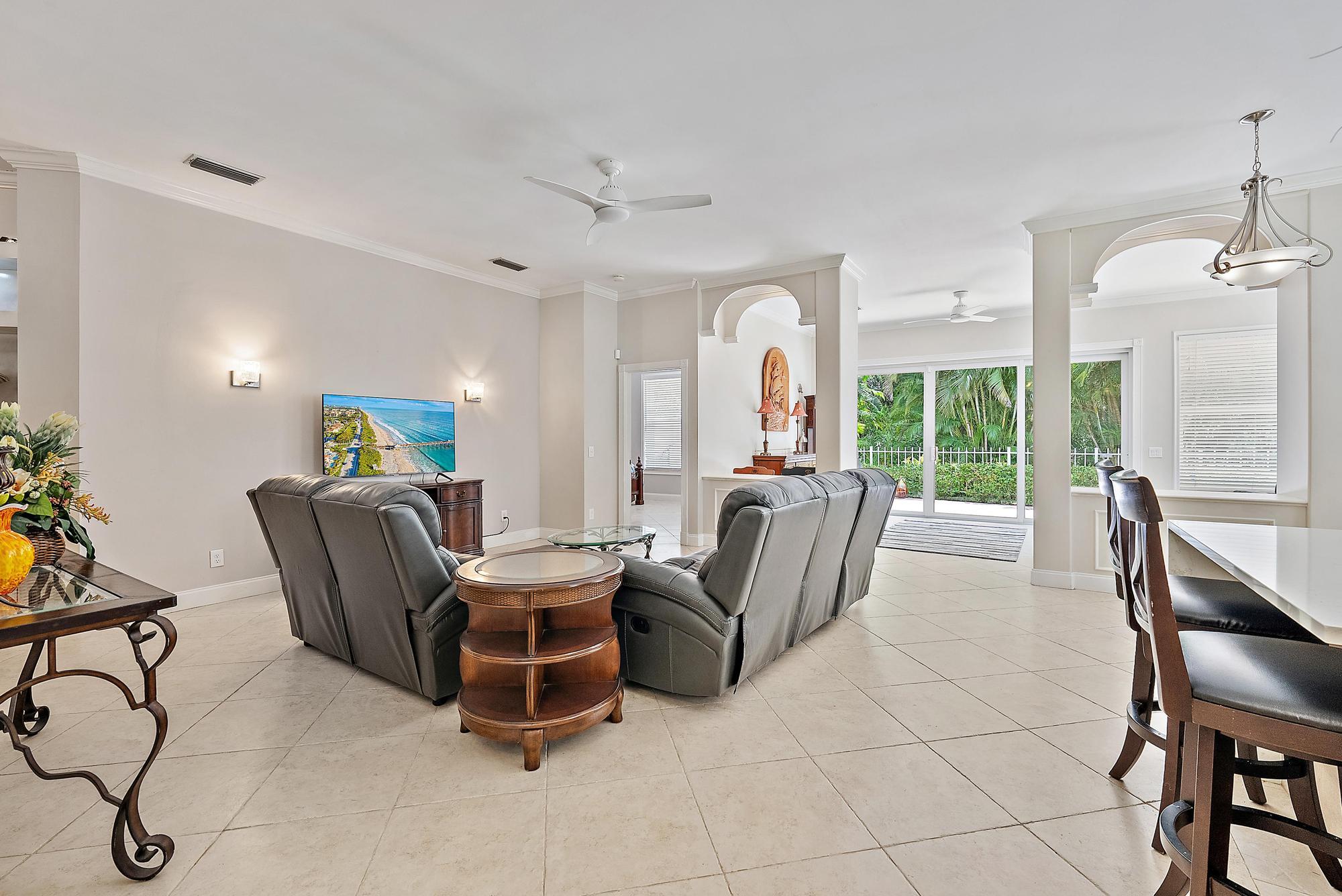 124 South Hampton Drive Jupiter, FL 33458 - Photo 11 of 39 a living room with furniture a ceiling fan and a large window