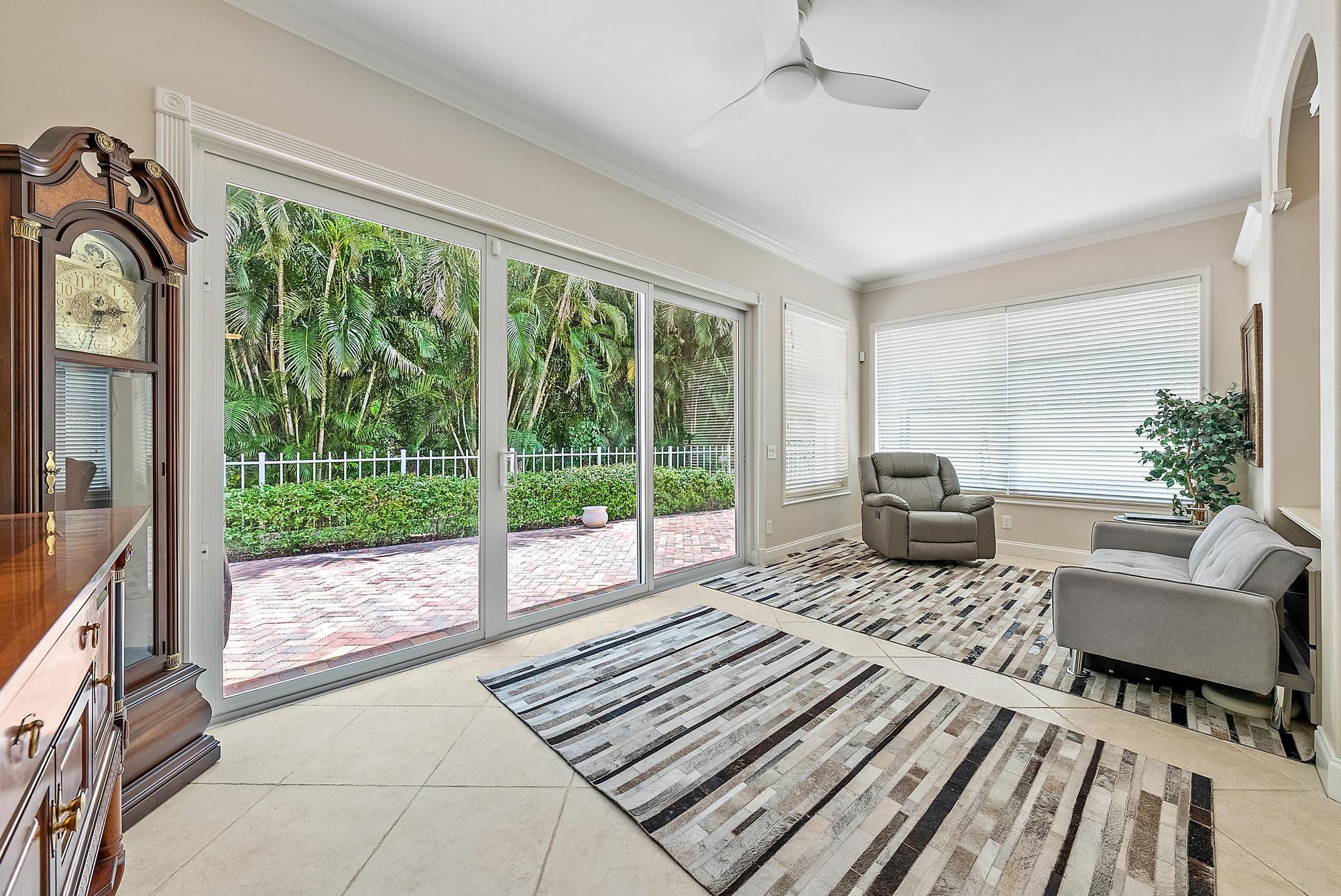 124 South Hampton Drive Jupiter, FL 33458 - Photo 12 of 39 a living room with furniture and a floor to ceiling window
