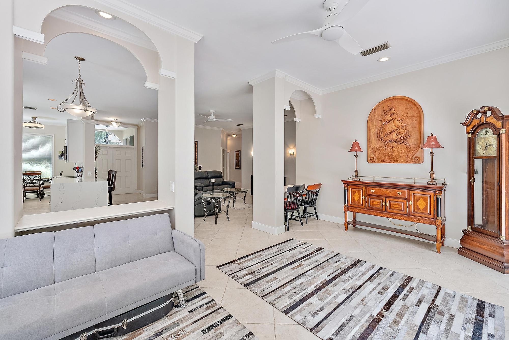 124 South Hampton Drive Jupiter, FL 33458 - Photo 13 of 39 a living room with furniture a table and chairs