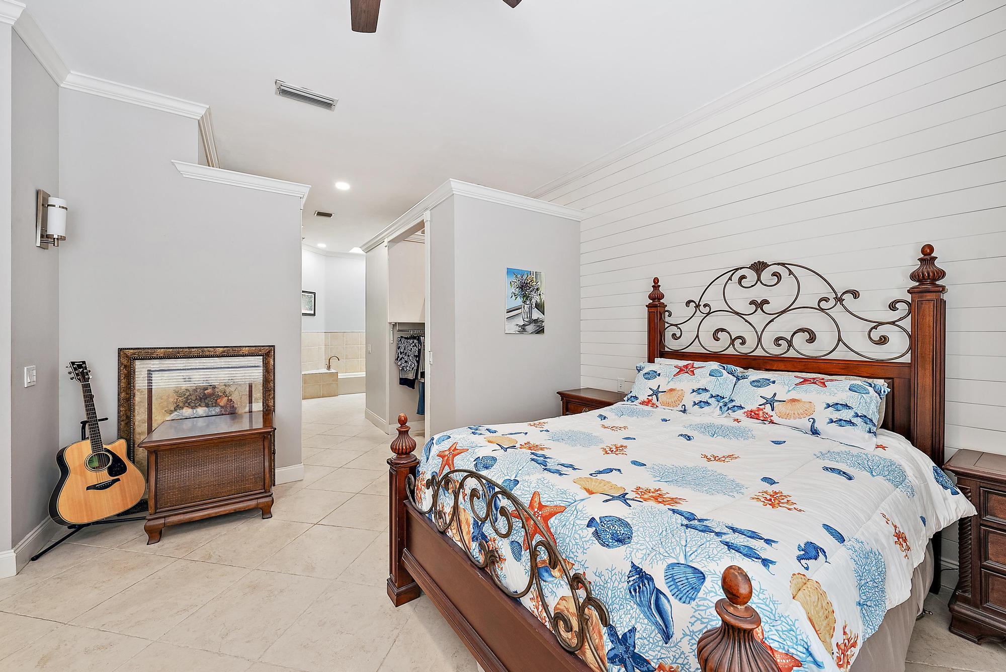 124 South Hampton Drive Jupiter, FL 33458 - Photo 14 of 39 a bedroom with a bed and a couch