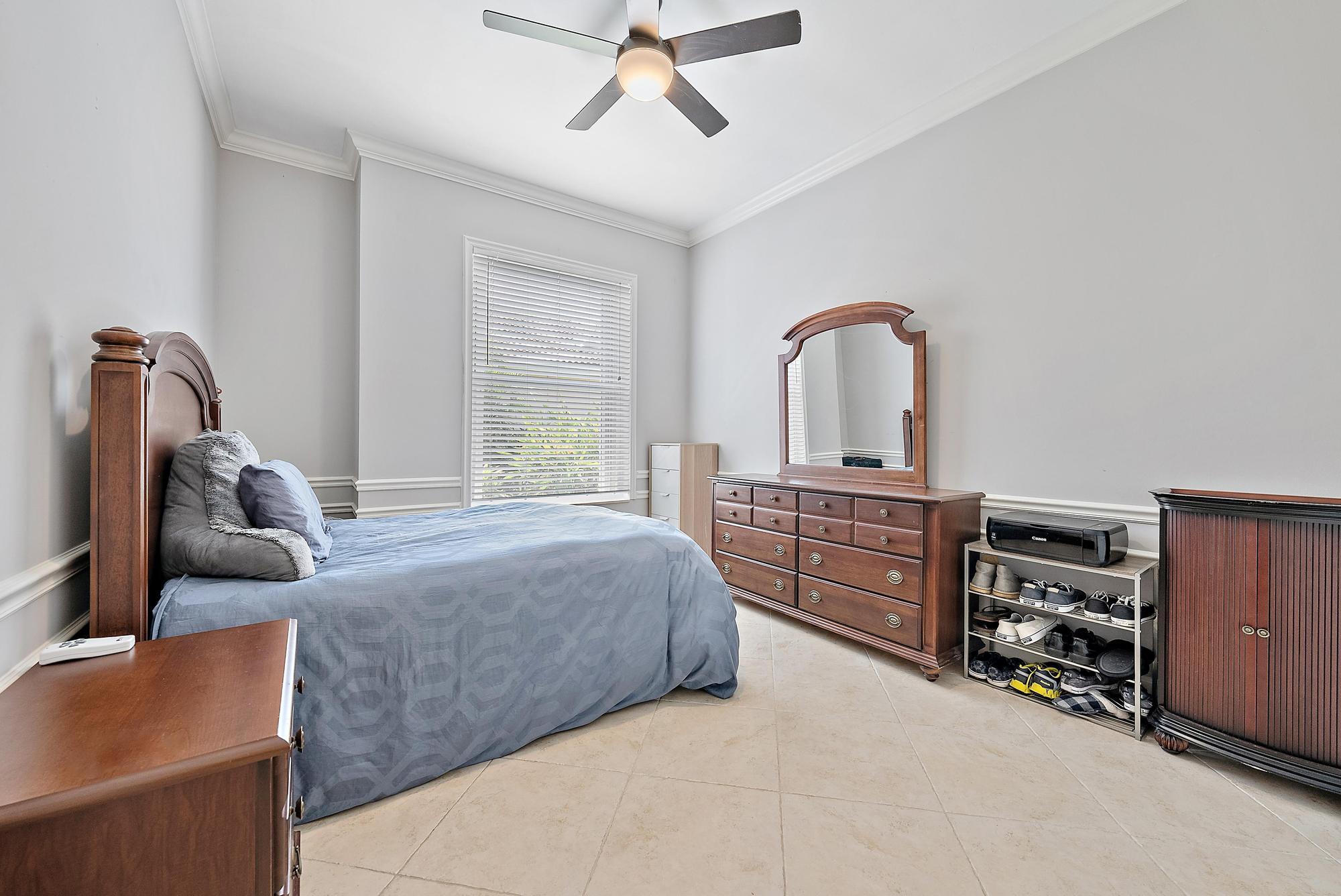 124 South Hampton Drive Jupiter, FL 33458 - Photo 20 of 39 a bed room with a bed and a dresser