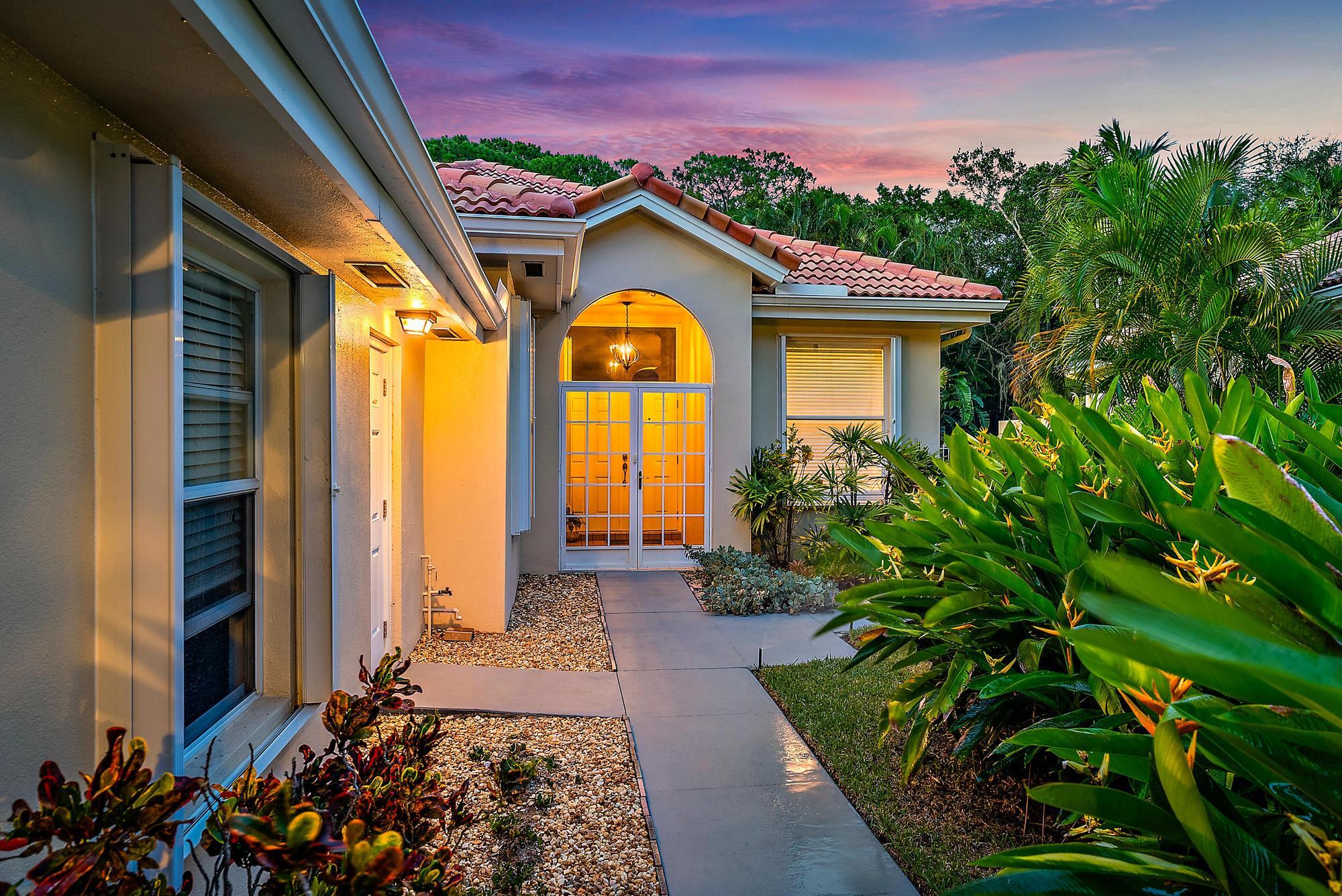 124 South Hampton Drive Jupiter, FL 33458 - Photo 22 of 39 a front view of a house with a yard