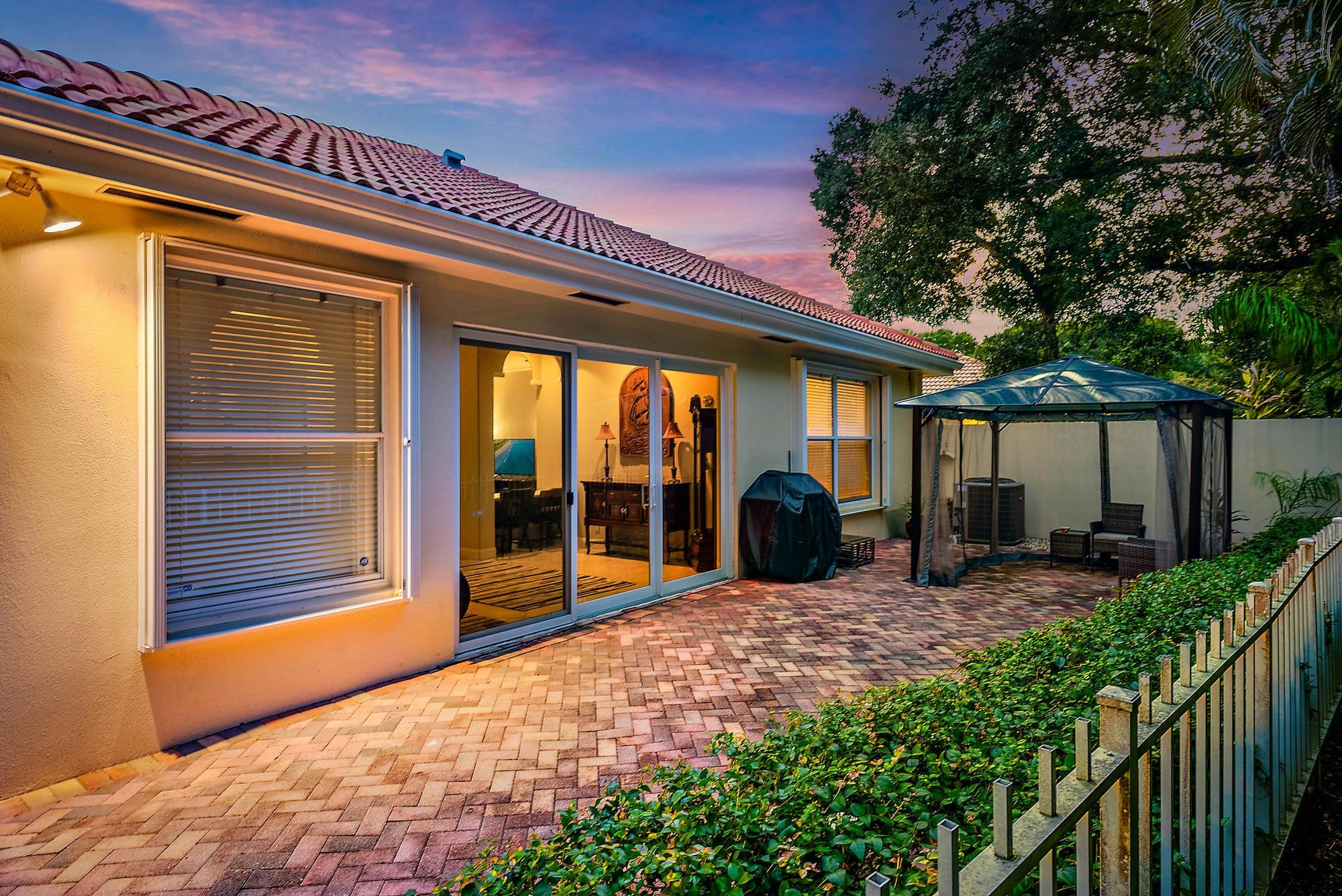 124 South Hampton Drive Jupiter, FL 33458 - Photo 25 of 39 a view of a house with backyard porch and furniture