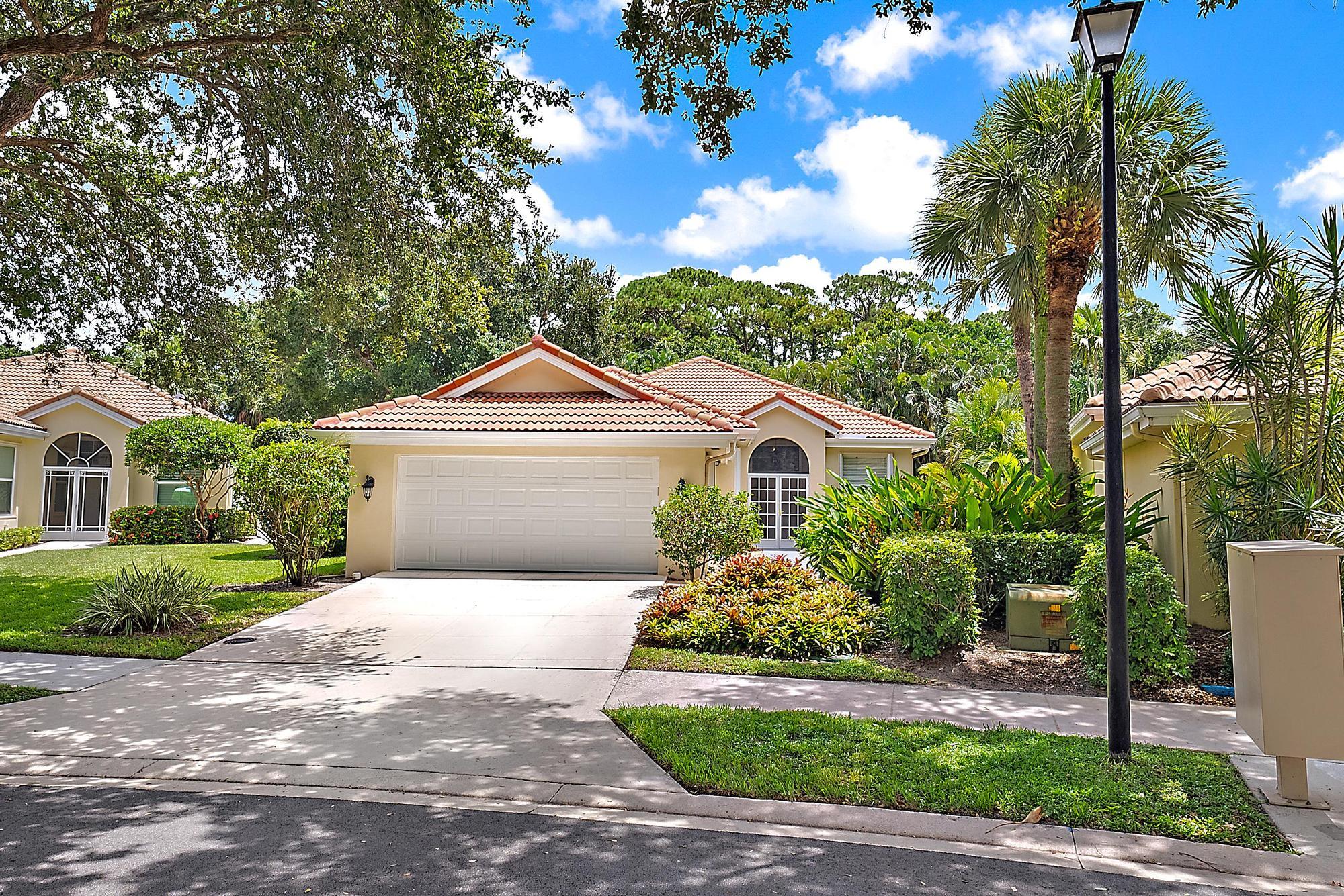 124 South Hampton Drive Jupiter, FL 33458 - Photo 27 of 39 a front view of a house with a yard and garage