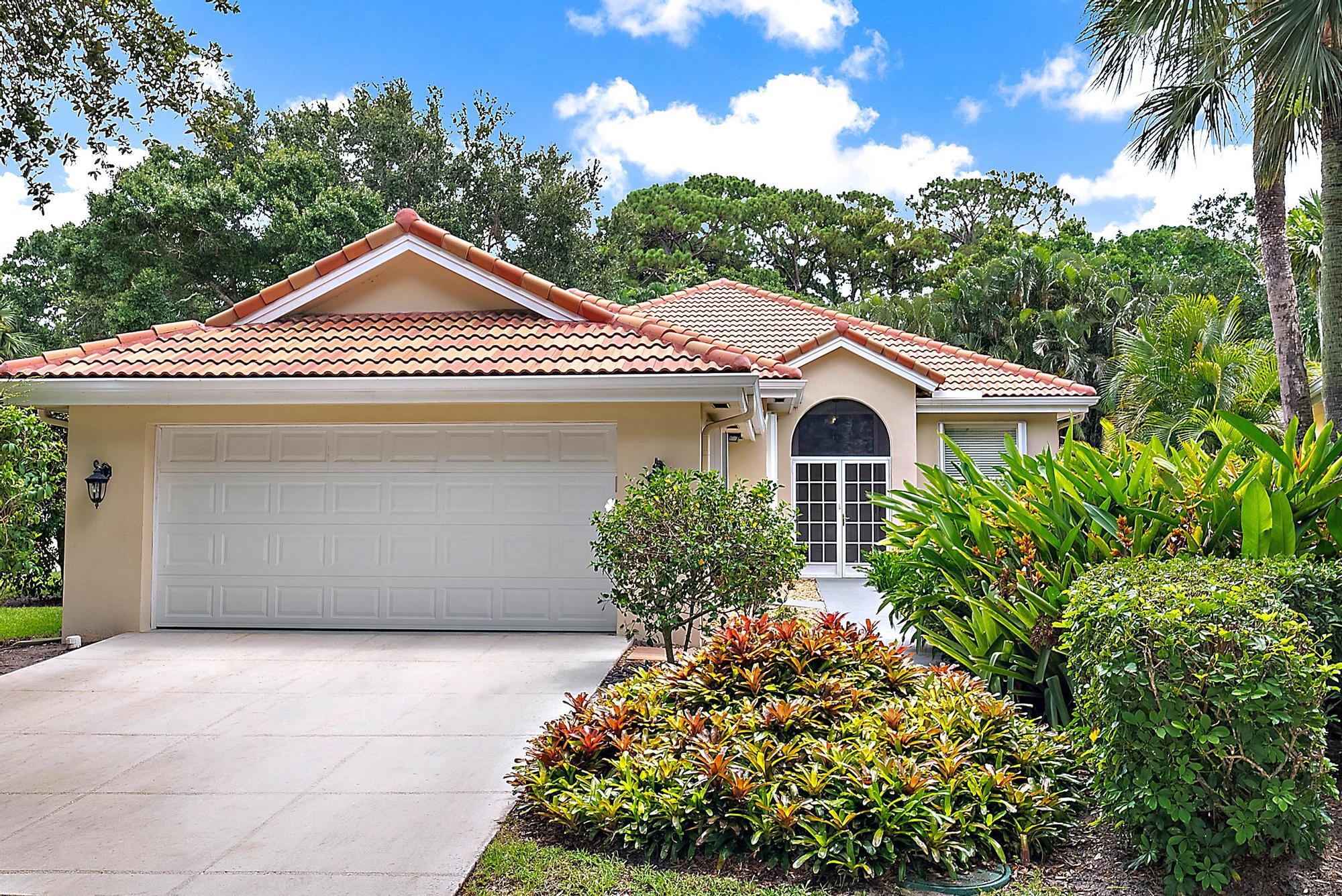 124 South Hampton Drive Jupiter, FL 33458 - Photo 28 of 39 a front view of a house with garden