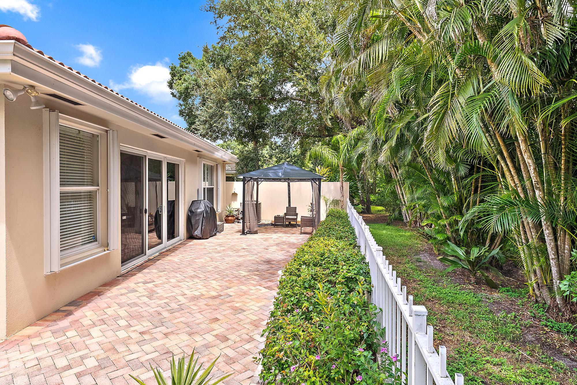 124 South Hampton Drive Jupiter, FL 33458 - Photo 32 of 39 a front view of a house with a yard