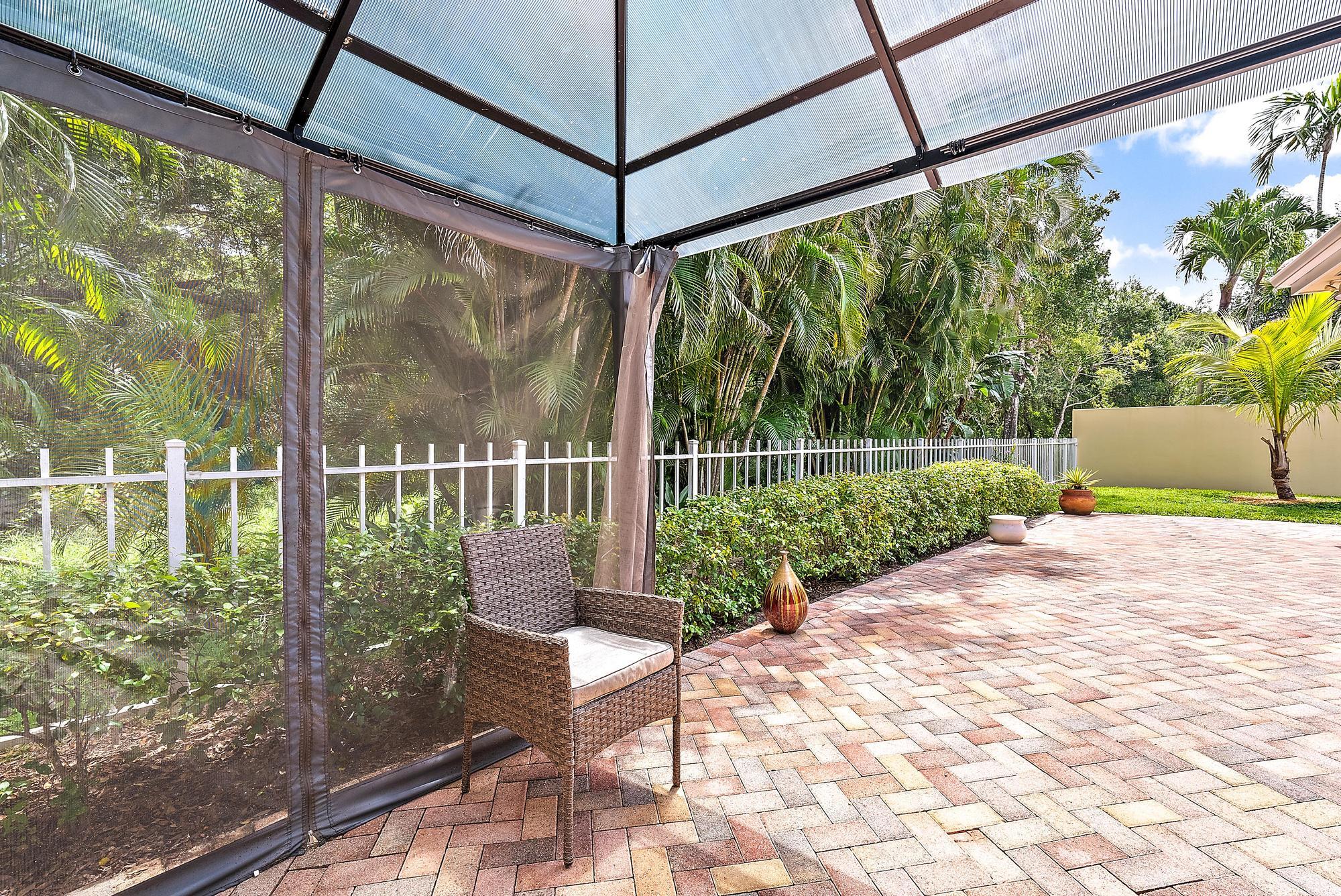 124 South Hampton Drive Jupiter, FL 33458 - Photo 34 of 39 a view of a chair and table in the garden