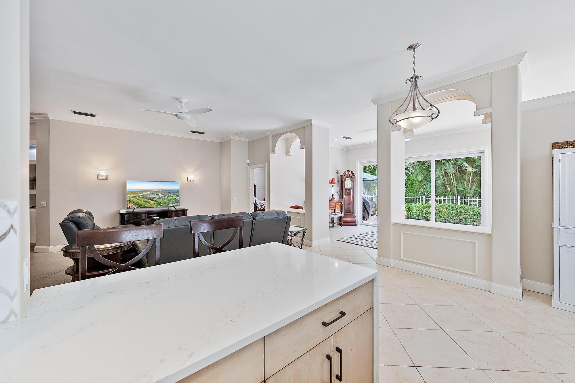 124 South Hampton Drive Jupiter, FL 33458 - Photo 7 of 39 a living room with furniture a window and chandelier