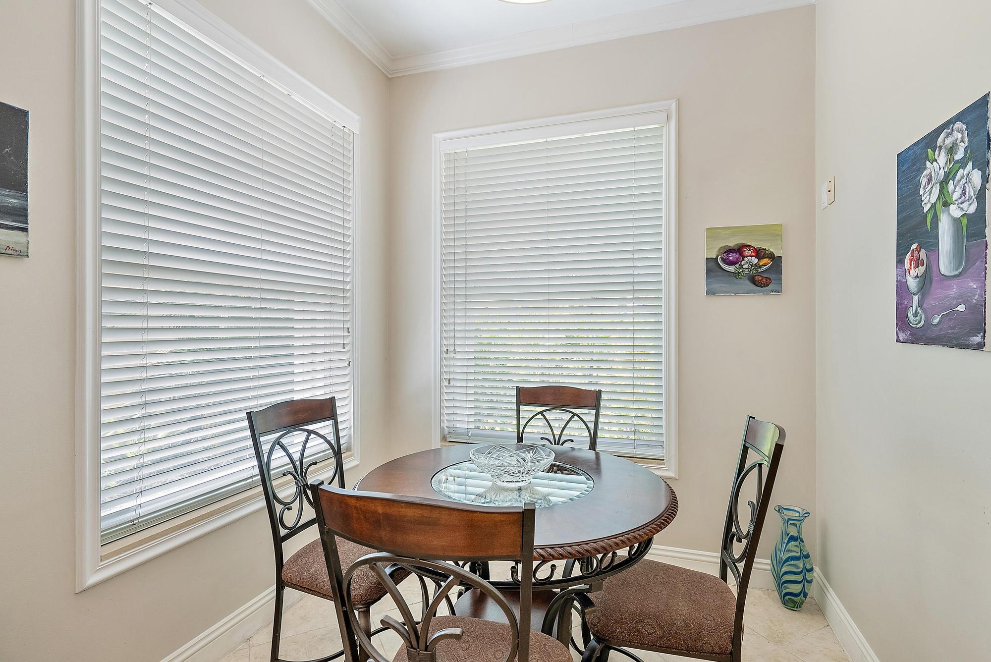 124 South Hampton Drive Jupiter, FL 33458 - Photo 8 of 39 a view of a dining room with furniture and wooden floor