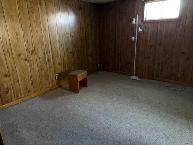 a view of an empty room with wooden walls