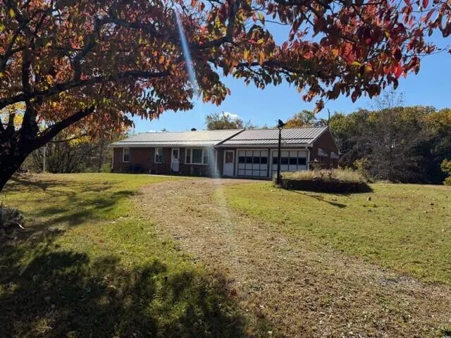 a view of a house with garden and sitting area