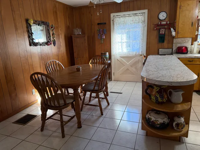 a dining room with furniture and wooden floor