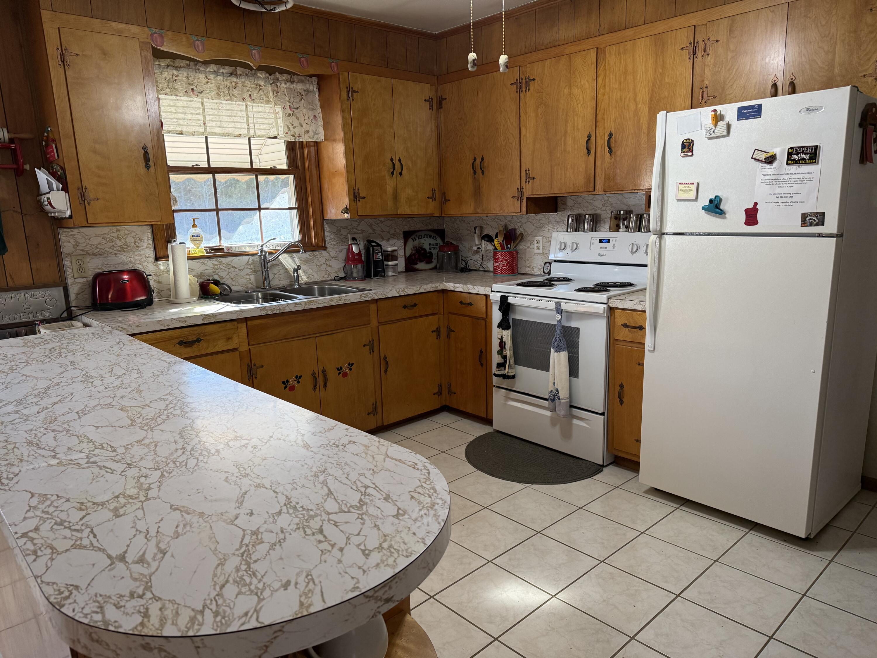 1028 Roswell Lane Blue Ridge, VA 24064 - Photo 5 of 21 a kitchen with a white cabinets and white appliances