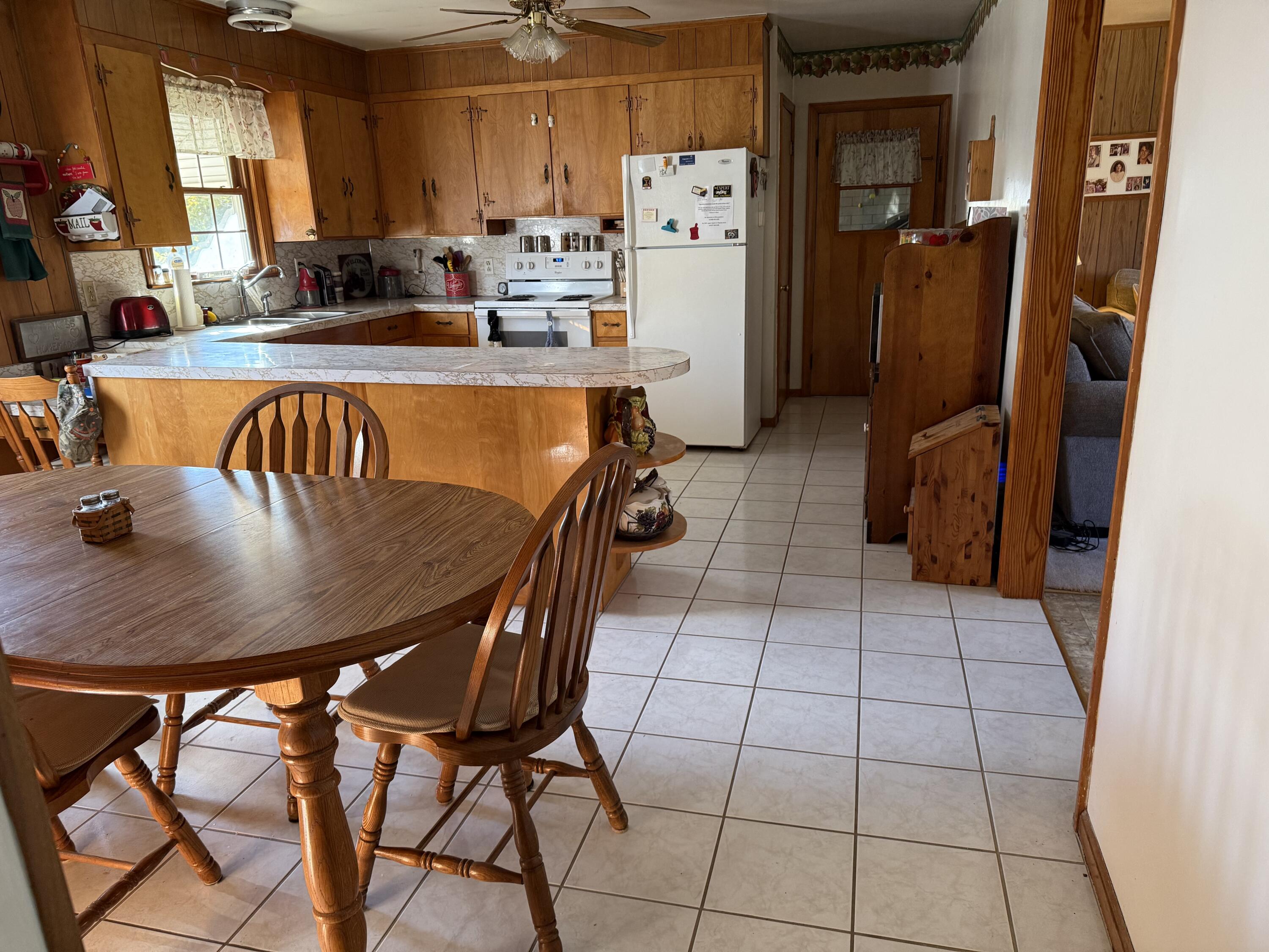 1028 Roswell Lane Blue Ridge, VA 24064 - Photo 6 of 21 a kitchen with stainless steel appliances granite countertop a table chairs and a refrigerator