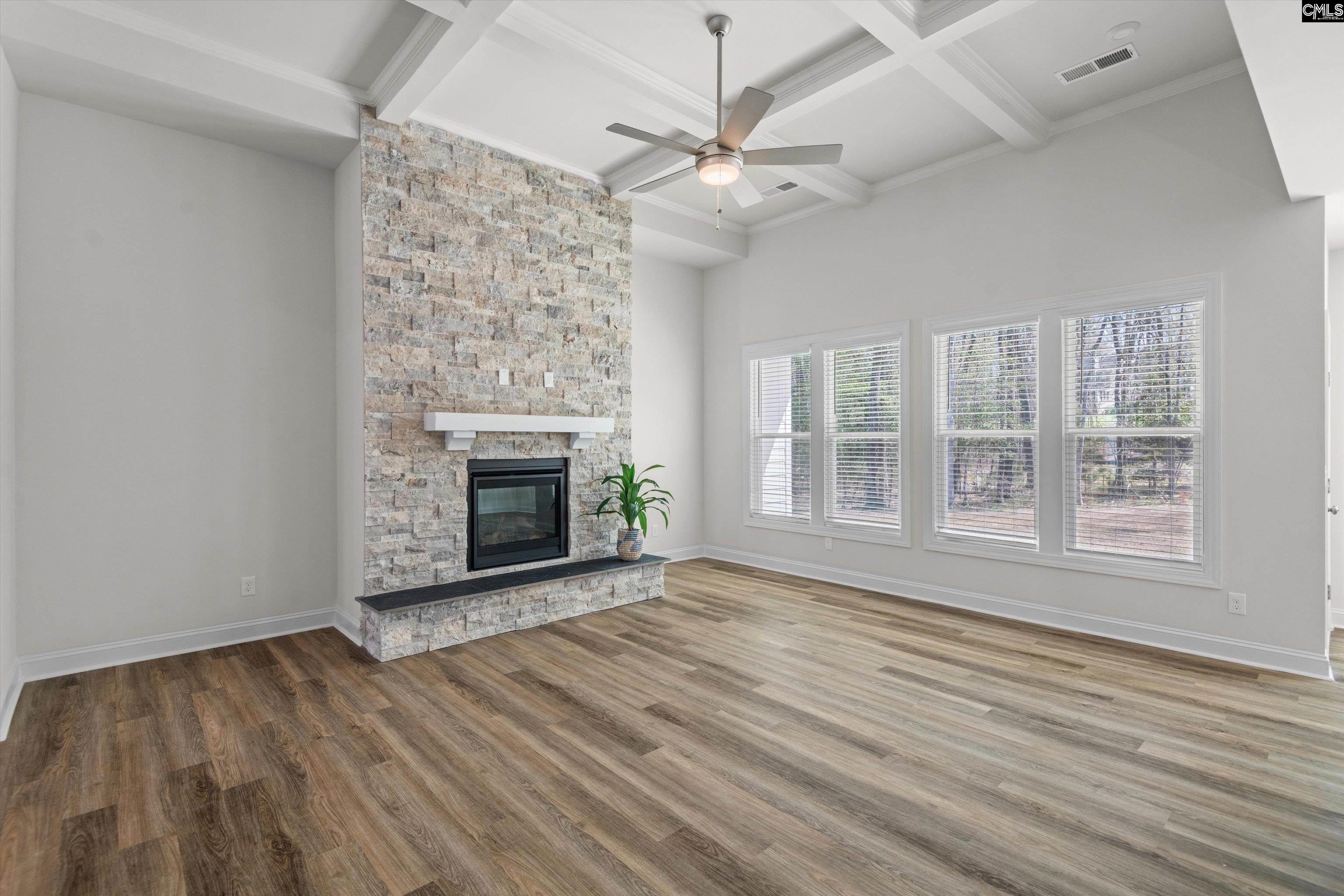 558 Wild Ginger Loop Irmo, SC 29063 - Photo 10 of 42 a view of an empty room with wooden floor fireplace and a window