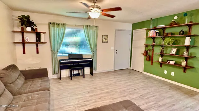 a living room with furniture a window and bookshelf