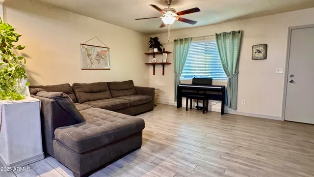 a living room with furniture and a wooden floor