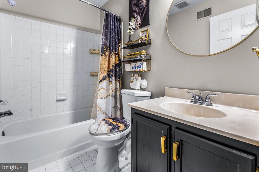 11409 Hermosa Drive Laurel, MD 20708 - Photo 24 of 28 a bathroom with a sink a toilet and shower