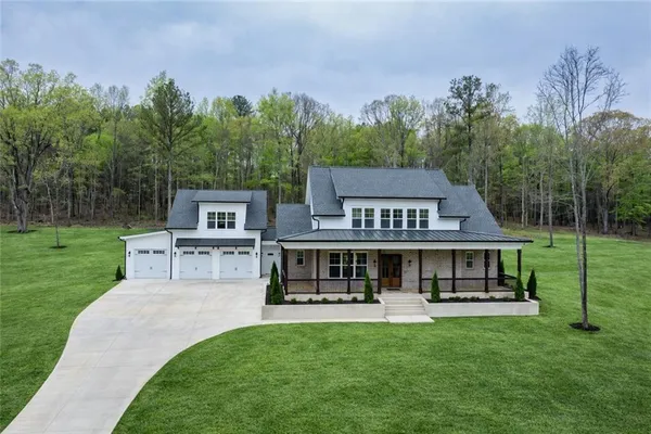 a view of a house with a yard porch and sitting area