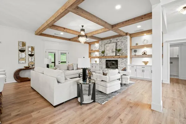 a living room with furniture a fireplace and a large window