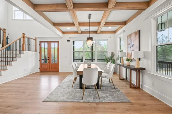 a living room with furniture and a chandelier