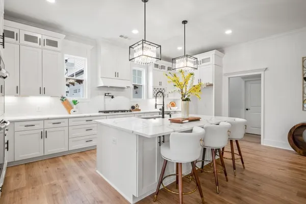 a kitchen with stainless steel appliances a sink a stove and cabinets