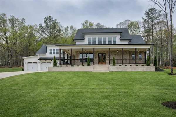a view of a house with backyard porch and sitting area
