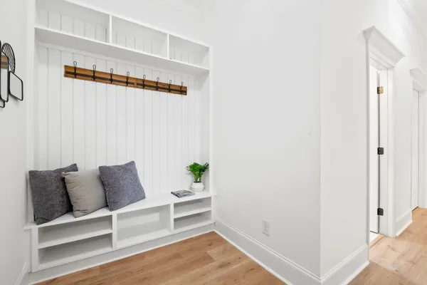 a spacious bedroom with a bed and wooden floor