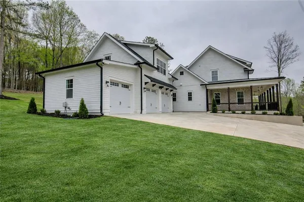 a backyard of a house with table and chairs