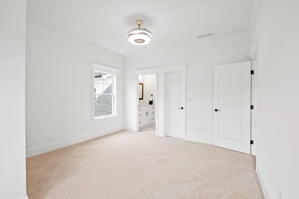 a view of a big room with a big yard and large trees