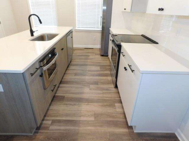 139 Pacer Place Atlanta, GA 30342 - Photo 13 of 31 a kitchen with sink cabinets and entryway