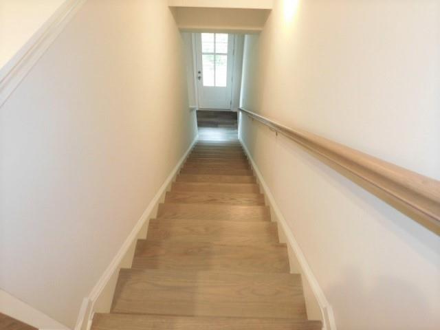 139 Pacer Place Atlanta, GA 30342 - Photo 8 of 31 a view of a hallway with wooden floor and staircase