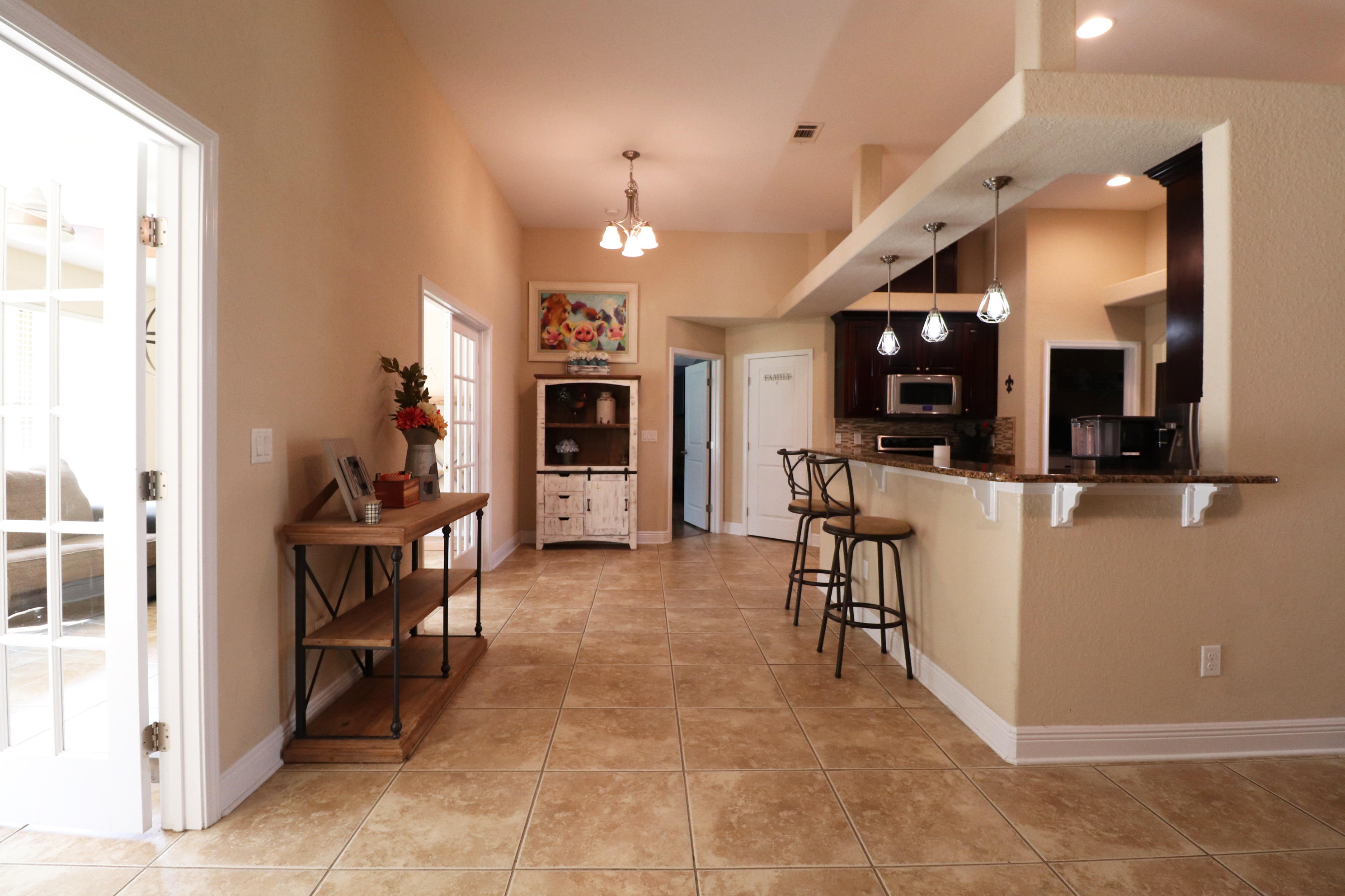 6181 Hummingbird Lane Crestview, FL 32536 - Photo 11 of 56 a view of a kitchen with kitchen island stainless steel appliances refrigerator stove microwave and stove