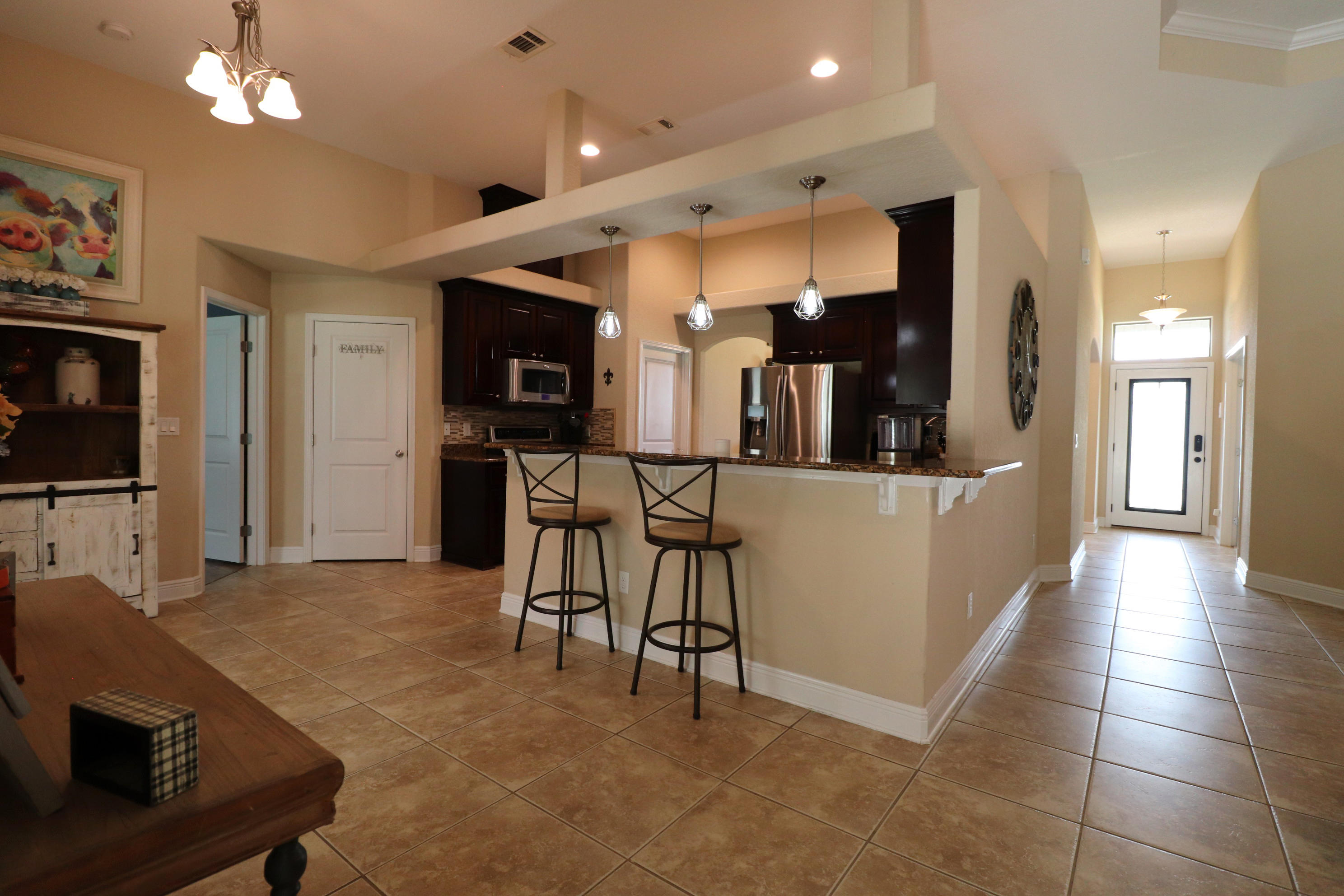 6181 Hummingbird Lane Crestview, FL 32536 - Photo 12 of 56 a view of a living room and kitchen with furniture