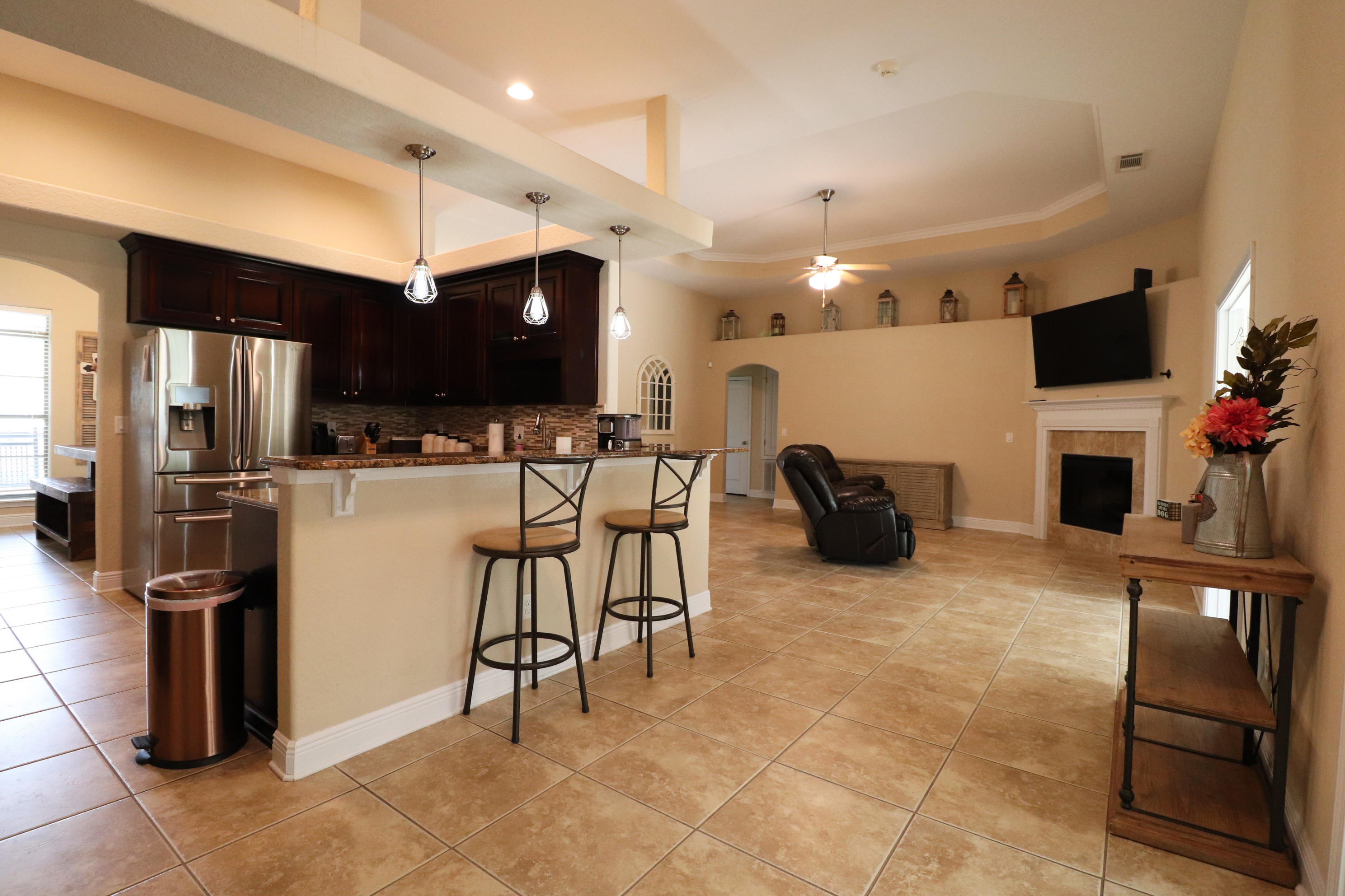 6181 Hummingbird Lane Crestview, FL 32536 - Photo 13 of 56 a kitchen with stainless steel appliances kitchen island granite countertop a refrigerator and a stove top oven