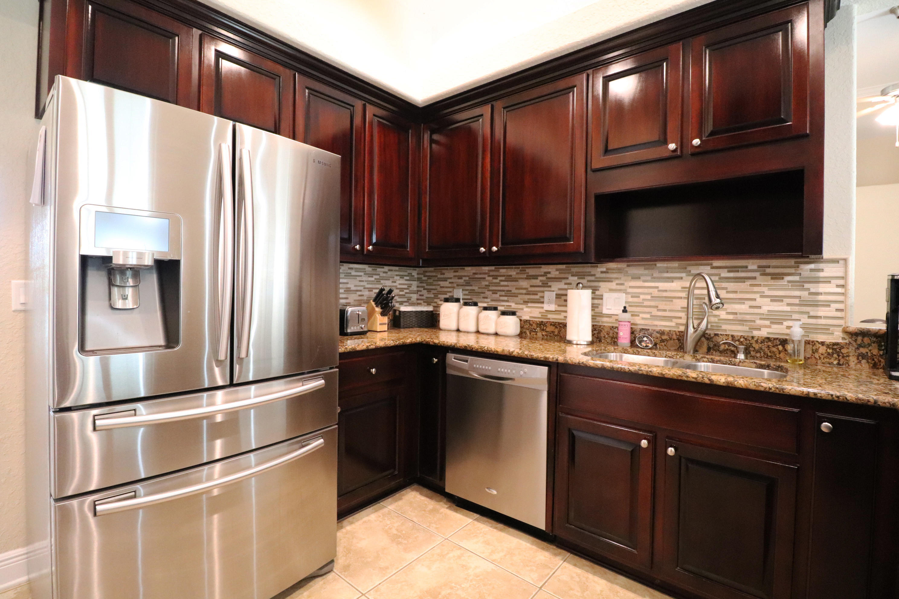 6181 Hummingbird Lane Crestview, FL 32536 - Photo 20 of 56 a kitchen with granite countertop stainless steel appliances and wooden cabinets