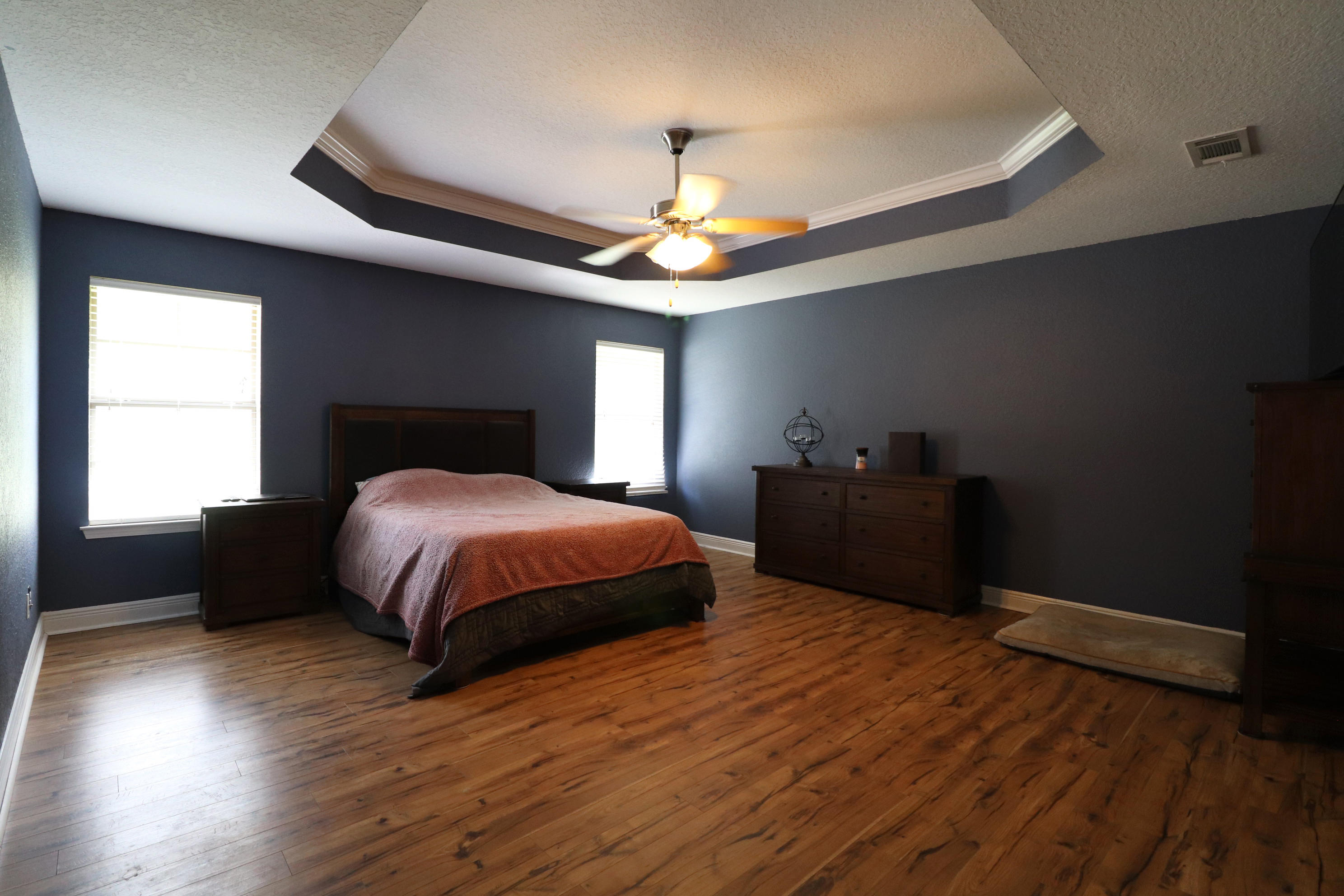 6181 Hummingbird Lane Crestview, FL 32536 - Photo 23 of 56 a bedroom with a bed and a chandelier