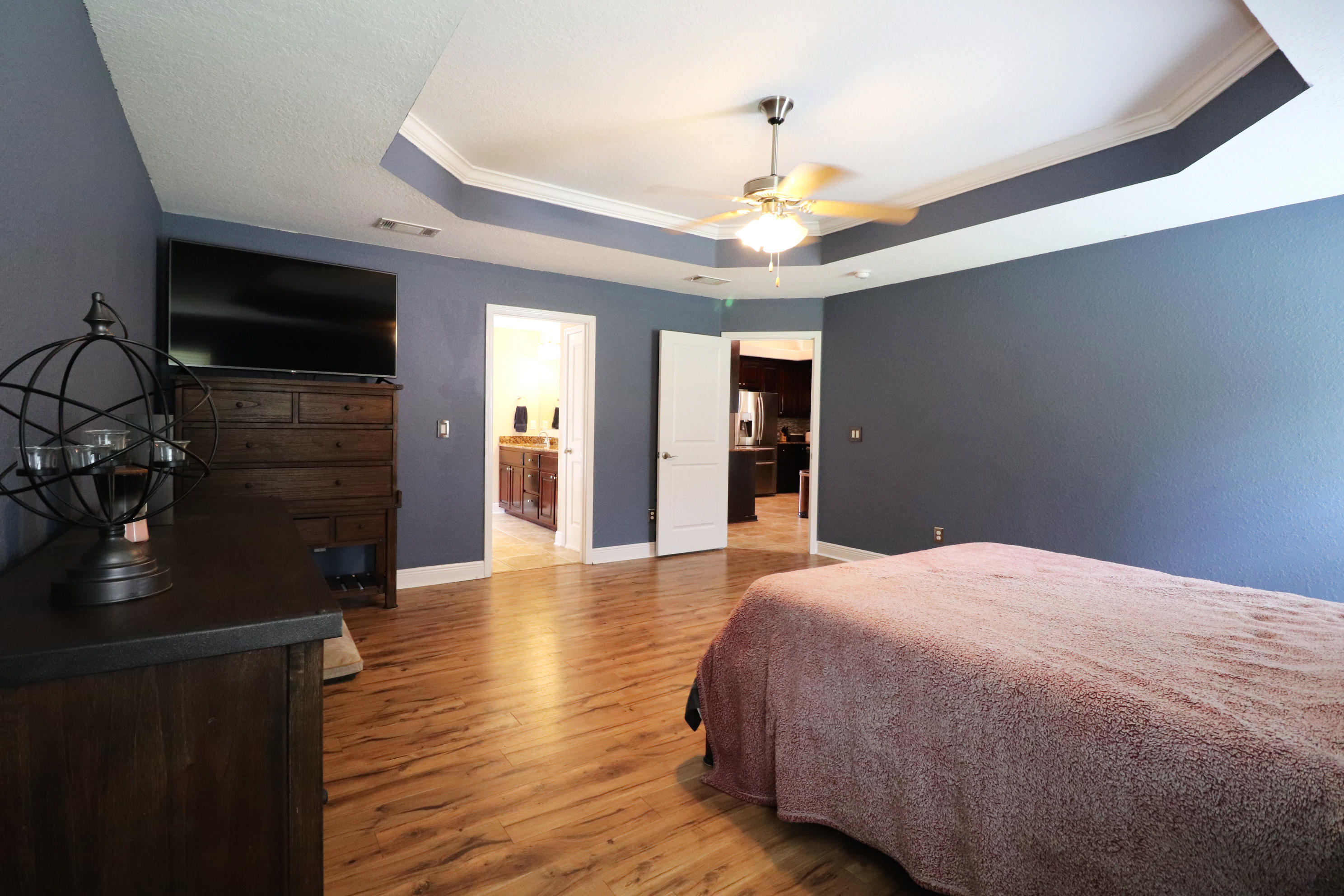 6181 Hummingbird Lane Crestview, FL 32536 - Photo 25 of 56 a bedroom with a bed and a chandelier