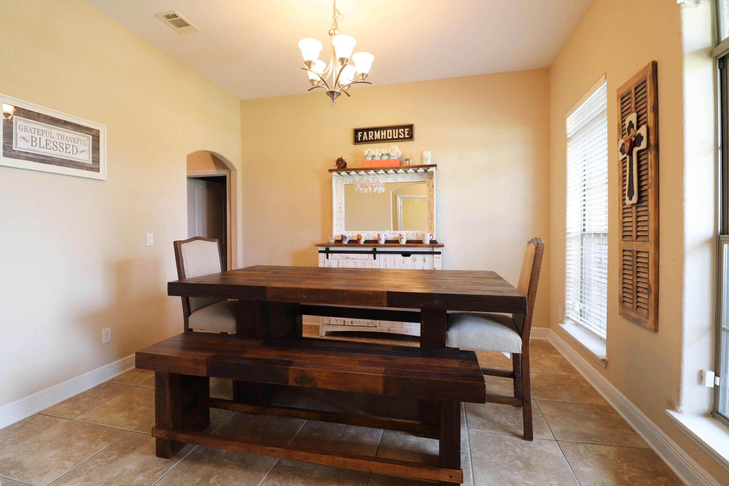 6181 Hummingbird Lane Crestview, FL 32536 - Photo 3 of 56 a view of hall way with furniture and chandelier