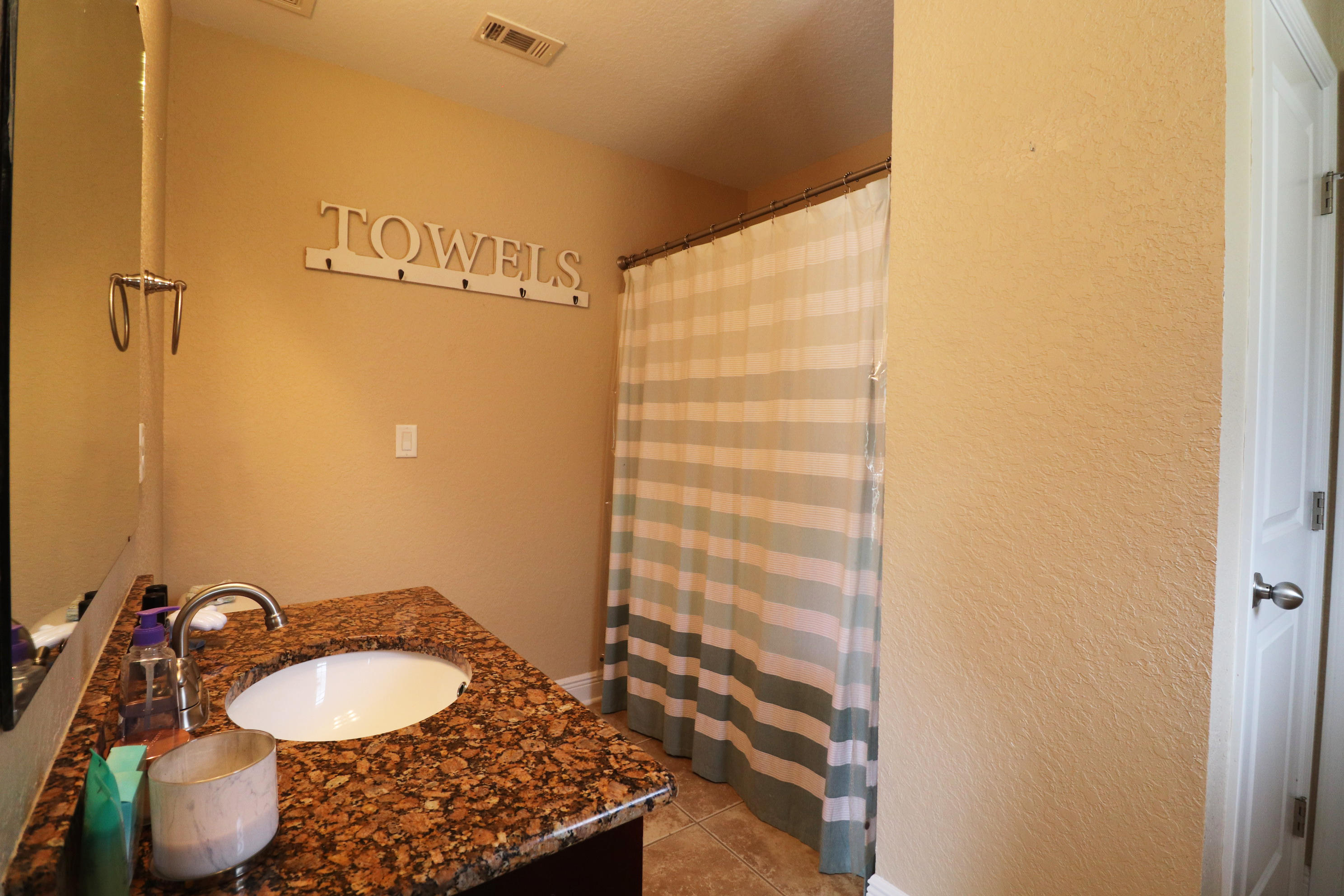 6181 Hummingbird Lane Crestview, FL 32536 - Photo 35 of 56 a bathroom with a granite countertop sink and a mirror