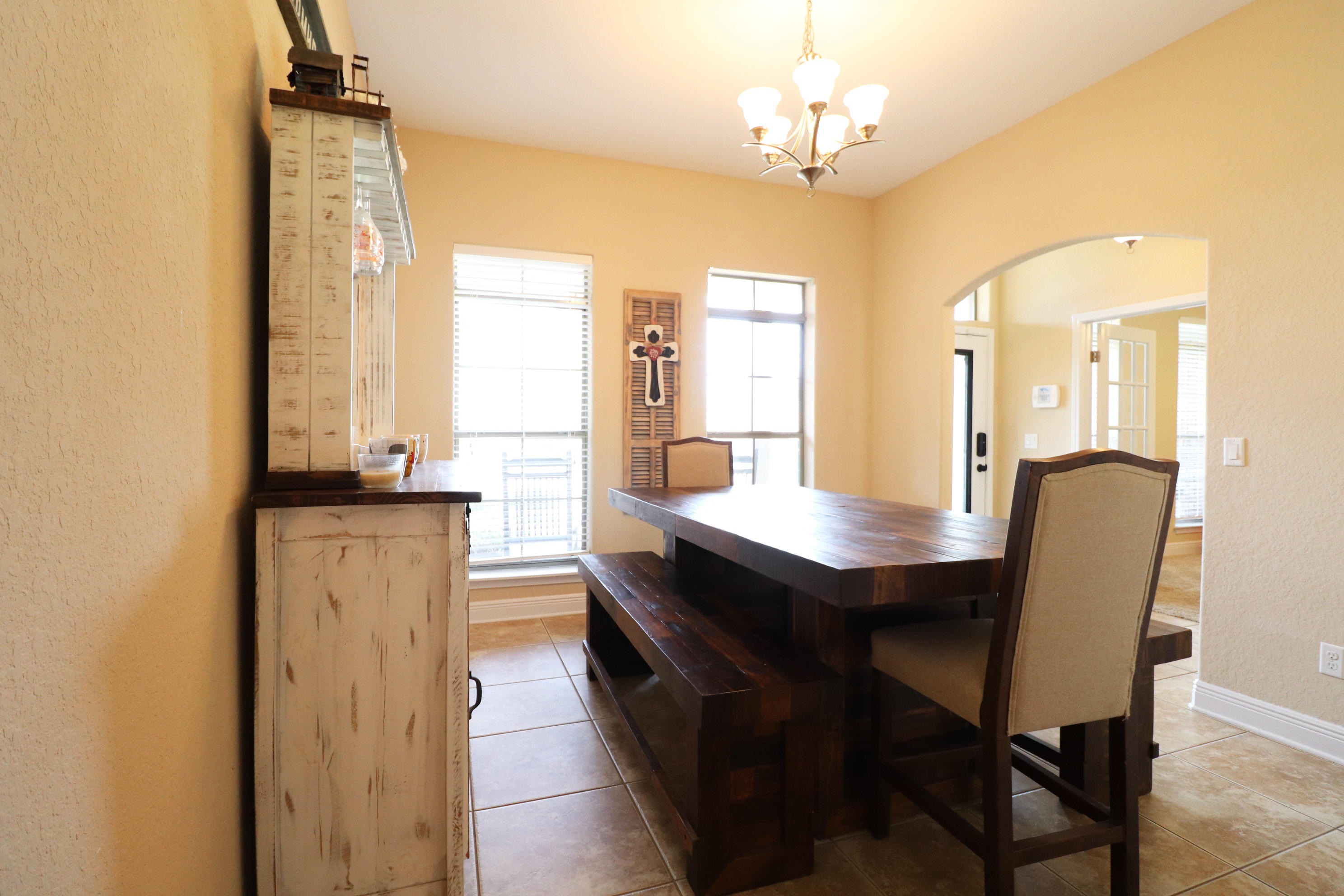 6181 Hummingbird Lane Crestview, FL 32536 - Photo 4 of 56 a dining room with a table chairs and chandelier